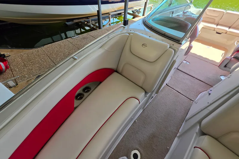 Slide: The Image of Interior of a 2016 Crownline 275 SS boat with beige and red seating. - 34