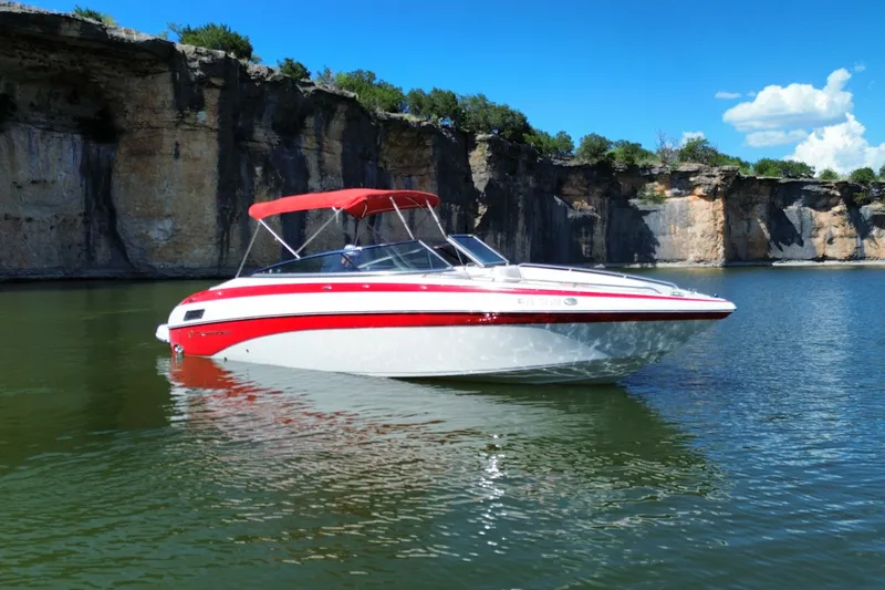 Slide: The Image of 2016 Crownline 275 SS boat on a scenic lake with rocky cliffs. - 9