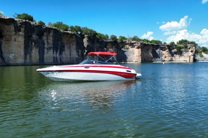 Slide: The Image of 2016 Crownline 275 SS boat on a scenic lake with rocky cliffs. - 7