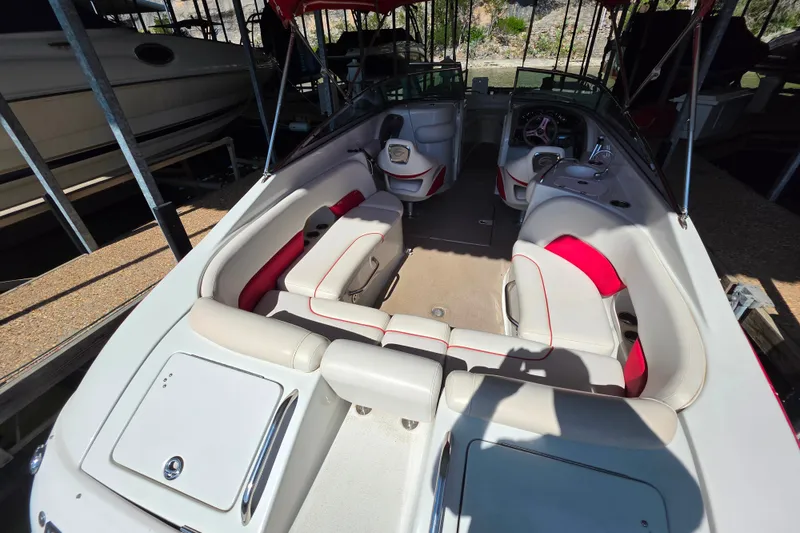 Slide: The Image of The image shows the cockpit of a 2016 Crownline 275 SS boat with red and white seating. - 24