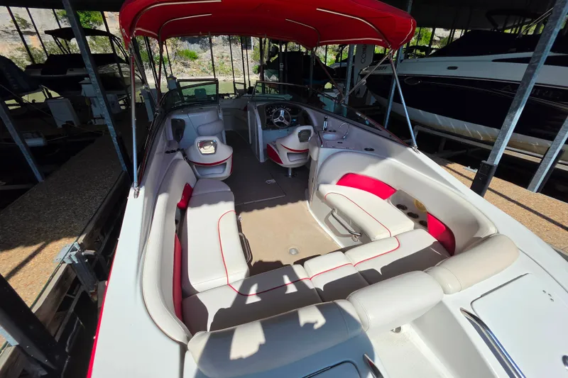Slide: The Image of 2016 Crownline 275 SS boat interior with red canopy and spacious seating. - 26