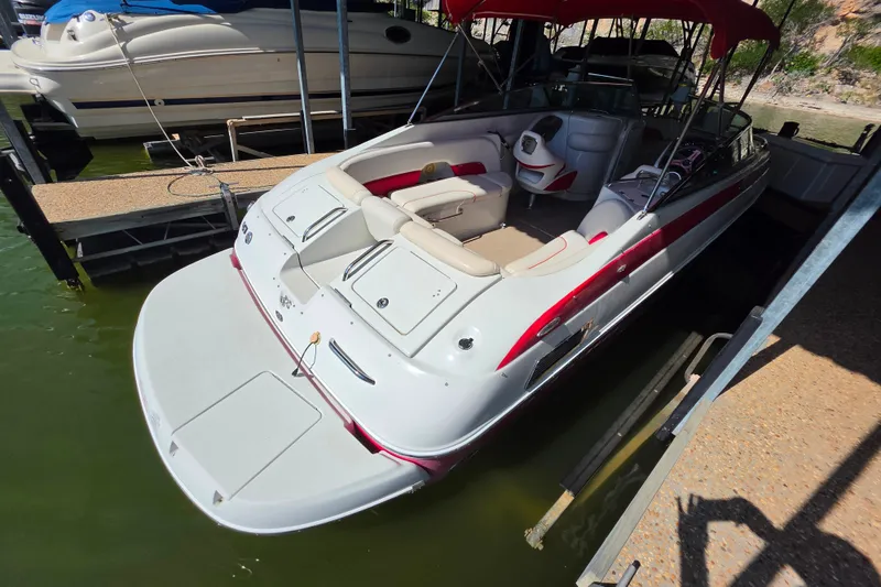 Slide: The Image of 2016 Crownline 275 SS boat docked, featuring spacious seating and sleek design. - 14