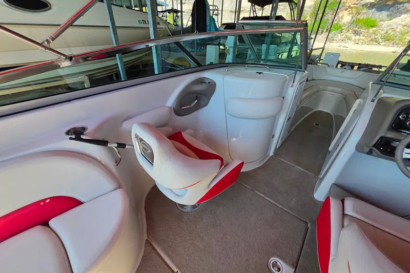 Slide: The Image of Interior of a 2016 Crownline 275 SS boat with red and white seating. - 28