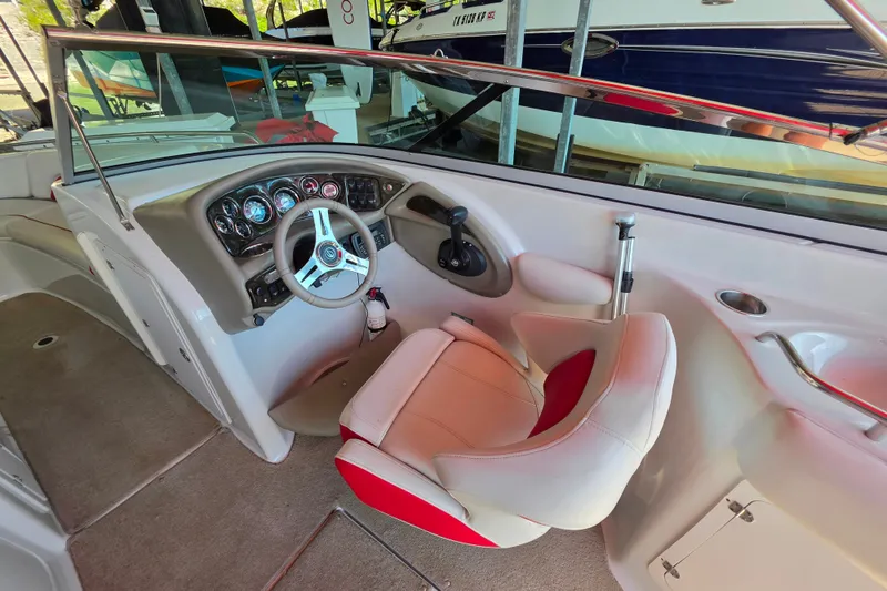 Slide: The Image of Interior view of 2016 Crownline 275 SS boat cockpit with steering wheel and captain's chair. - 23