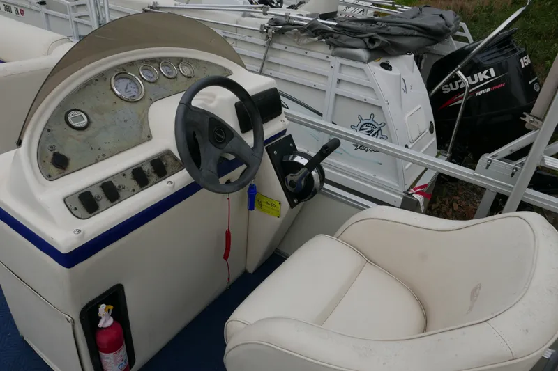 Slide: The Image of 2002 Crest 20 Sport boat dashboard with steering wheel and Suzuki outboard motor. - 9