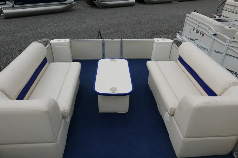 Slide: The Image of Interior of a 2002 Crest 20 Sport pontoon boat with white seating and blue carpet. - 7