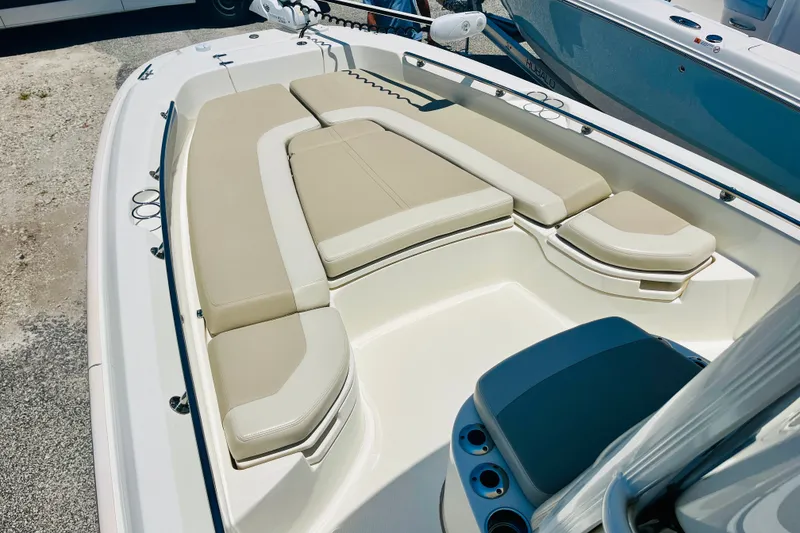 Slide: The Image of 2018 Boston Whaler 240 Dauntless boat interior with beige seating and cup holders. - 16