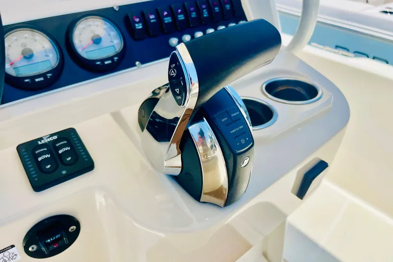 Slide: The Image of Control panel of a 2018 Boston Whaler 240 Dauntless boat with throttle and gauges. - 21