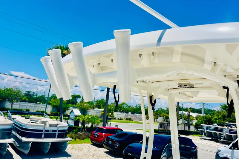 Slide: The Image of Boston Whaler 240 Dauntless 2018 boat with rod holders, parked near other vehicles. - 22