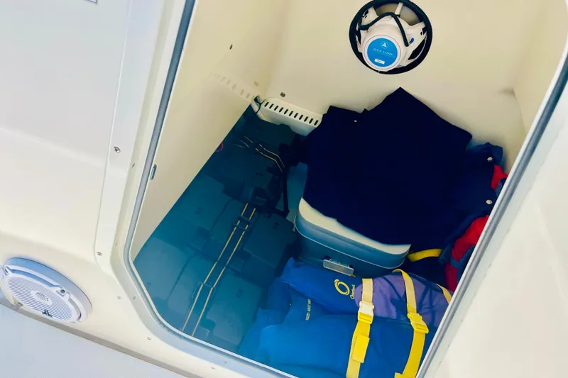 Slide: The Image of Storage compartment of 2018 Boston Whaler 240 Dauntless with life jackets and gear. - 24