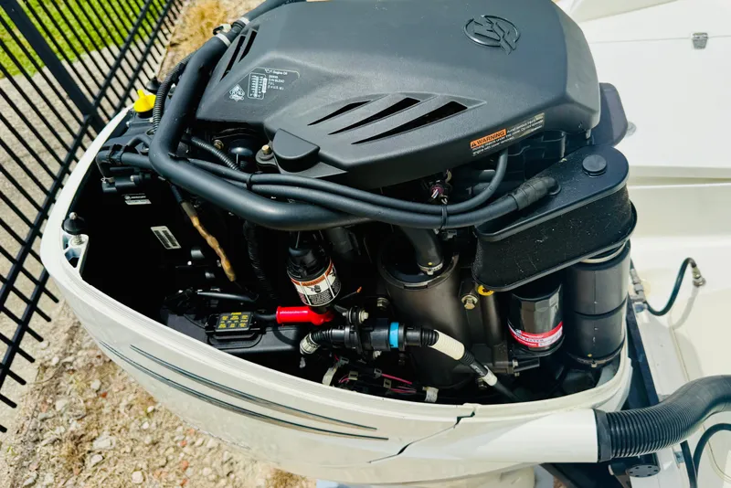 Slide: The Image of Close-up of a 2018 Boston Whaler 240 Dauntless boat engine, showcasing intricate components. - 26