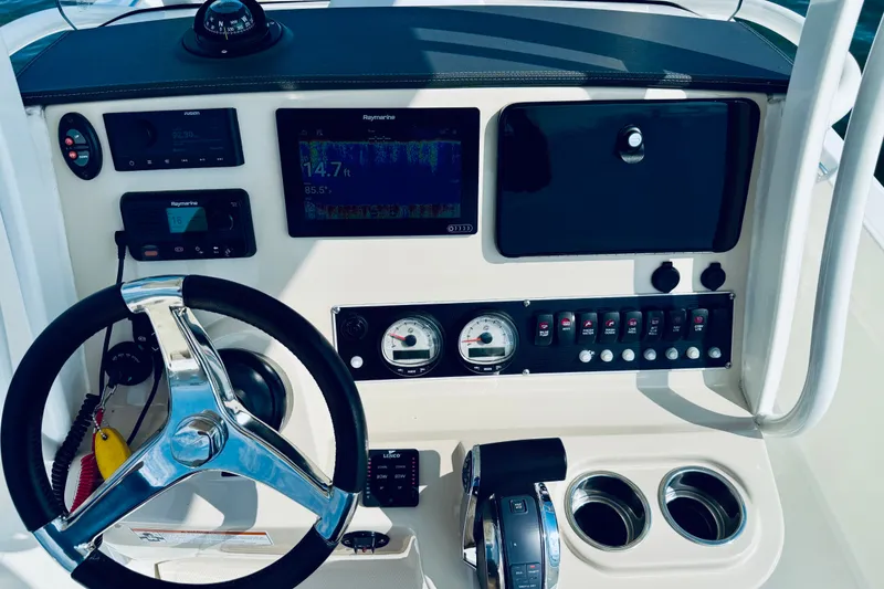 Slide: The Image of Control panel of a 2018 Boston Whaler 240 Dauntless boat with steering wheel and gauges. - 19