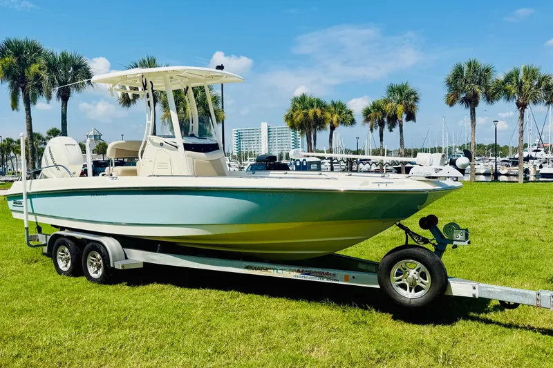 Slide: The Image of 2018 Boston Whaler 240 Dauntless boat on trailer, parked on grass near marina. - 5
