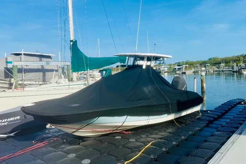 Slide: The Image of 2018 Boston Whaler 240 Dauntless boat covered at marina dock. - 25