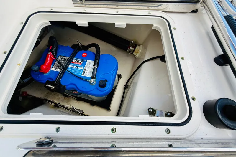 Slide: The Image of Battery compartment of a 2018 Boston Whaler 240 Dauntless boat, featuring an Optima battery. - 32