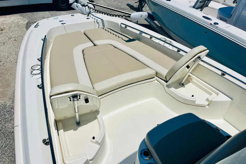 Slide: The Image of 2018 Boston Whaler 240 Dauntless boat interior with beige seating and storage compartments. - 17