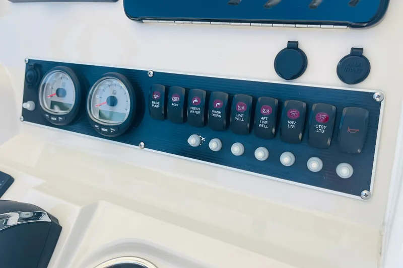 Slide: The Image of Control panel of a 2018 Boston Whaler 240 Dauntless boat with gauges and switches. - 20