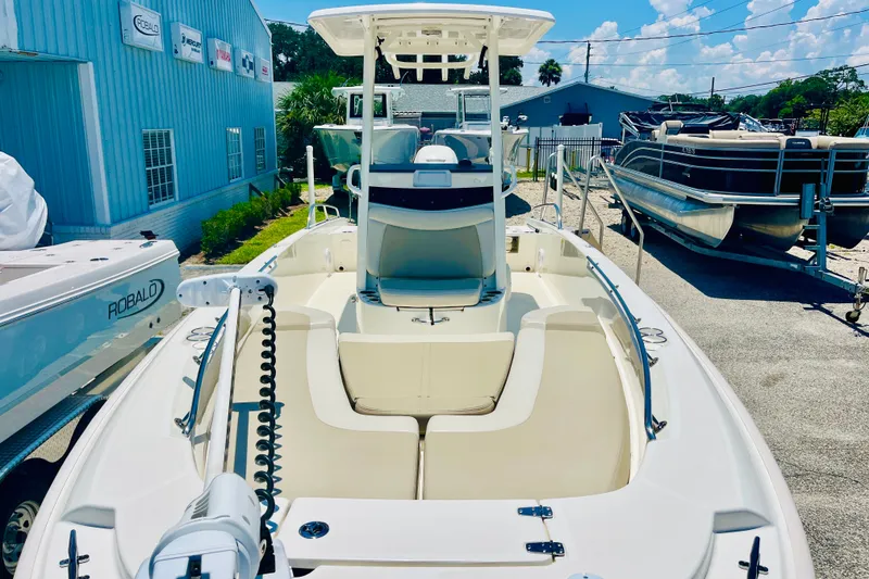 Slide: The Image of 2018 Boston Whaler 240 Dauntless boat displayed outdoors, showcasing sleek design and spacious seating. - 9