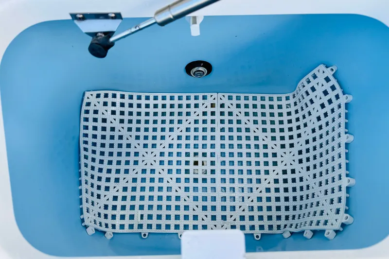 Slide: The Image of Livewell interior of 2018 Boston Whaler 240 Dauntless boat with grid mat. - 31
