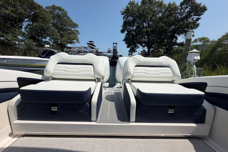 Slide: The Image of Luxurious seating on a 2027 Regal LX9 boat, featuring sleek white and navy upholstery. - 7