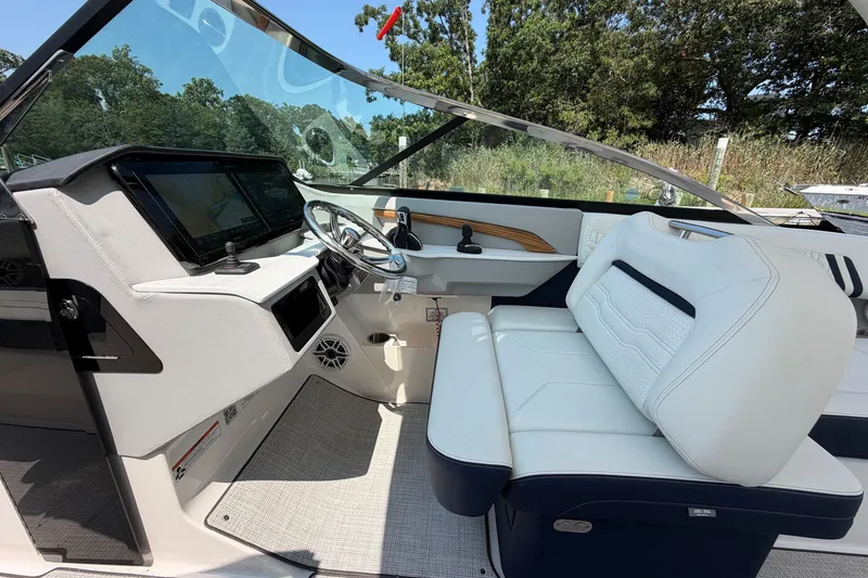 Slide: The Image of 2027 Regal LX9 boat interior with white seating and modern dashboard design. - 20
