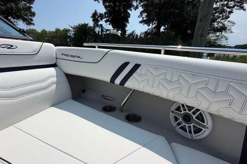 Slide: The Image of Luxurious interior of 2027 Regal LX9 boat with stylish white seating and speaker. - 26