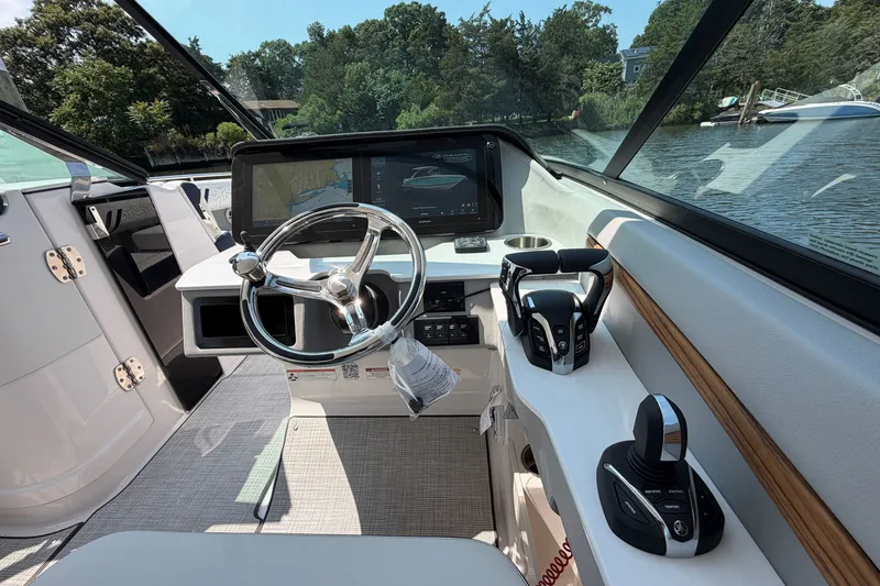 Slide: The Image of Interior of a 2027 Regal LX9 boat, featuring a modern helm with advanced controls. - 21
