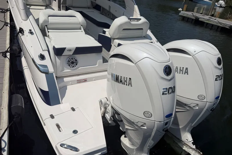 Slide: The Image of 2027 Regal LX9 boat with dual Yamaha 200 engines docked at a marina. - 3