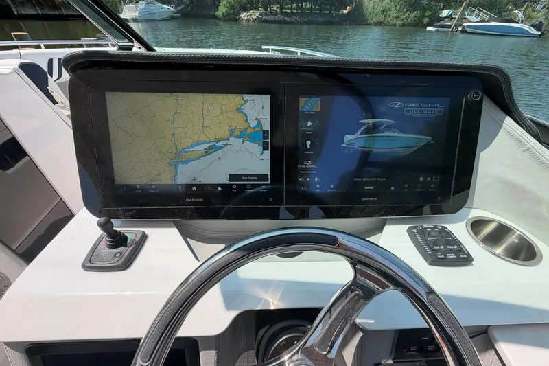 Slide: The Image of 2027 Regal LX9 boat dashboard with dual Garmin displays and navigation controls. - 23