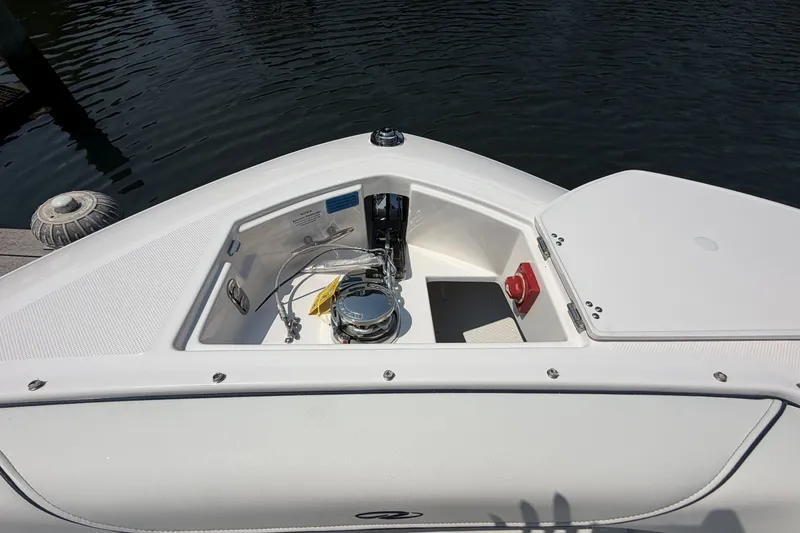 Slide: The Image of 2027 Regal LX9 boat bow with open storage compartment and visible hardware. - 28