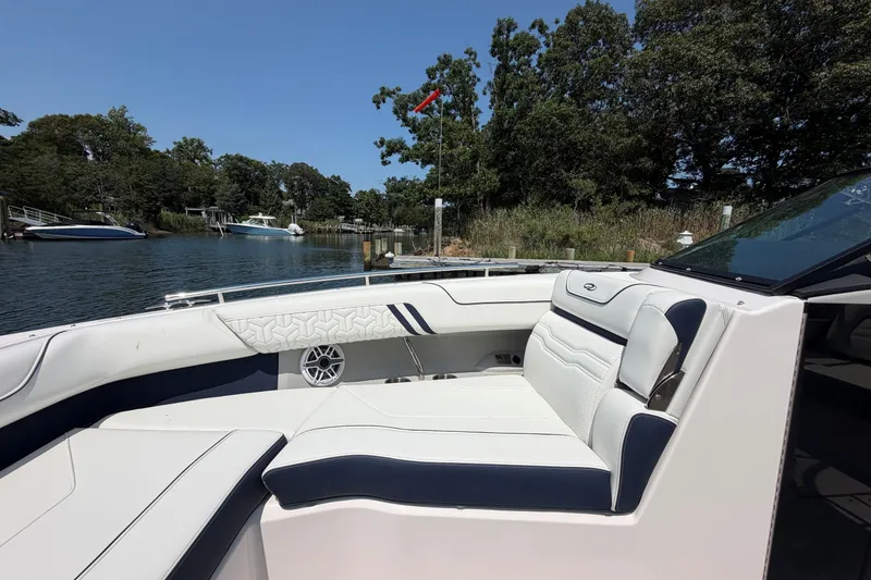 Slide: The Image of Luxurious 2027 Regal LX9 boat interior with elegant seating, docked by a scenic waterfront. - 27