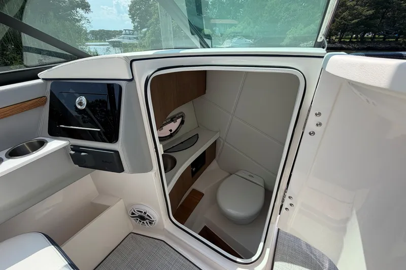 Slide: The Image of 2027 Regal LX9 boat interior with compact bathroom and modern amenities. - 18