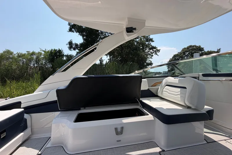 Slide: The Image of Luxurious 2027 Regal LX9 boat interior with open storage compartment and sleek seating. - 12