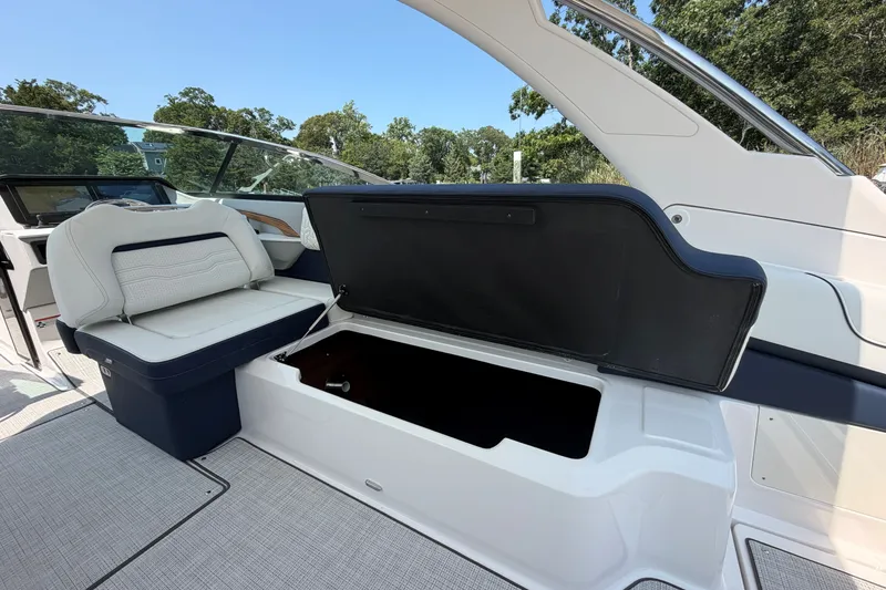 Slide: The Image of 2027 Regal LX9 boat interior with open storage compartment and cushioned seating. - 9