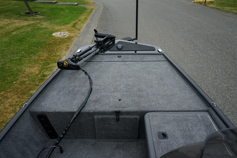 Slide: The Image of 2026 Tracker Bass Tracker Classic CC boat deck with trolling motor on a road. - 12