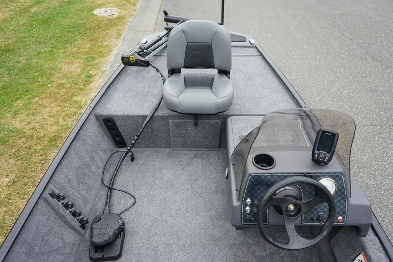 Slide: The Image of 2026 Tracker Bass Tracker Classic CC boat interior with steering console and seating. - 10