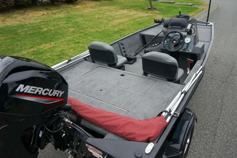 Slide: The Image of 2026 Tracker Bass Tracker Classic CC boat with Mercury engine, gray interior, and dual seats. - 5