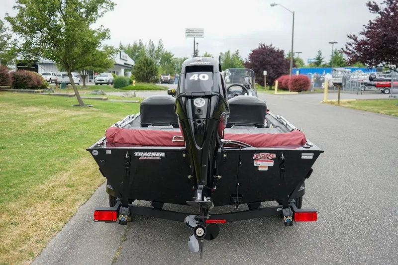 Slide: The Image of 2026 Tracker Bass Tracker Classic CC boat with Mercury engine, parked outdoors. - 4