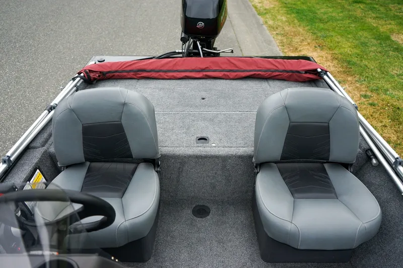 Slide: The Image of 2026 Tracker Bass Tracker Classic CC boat interior with two gray seats and steering wheel. - 6