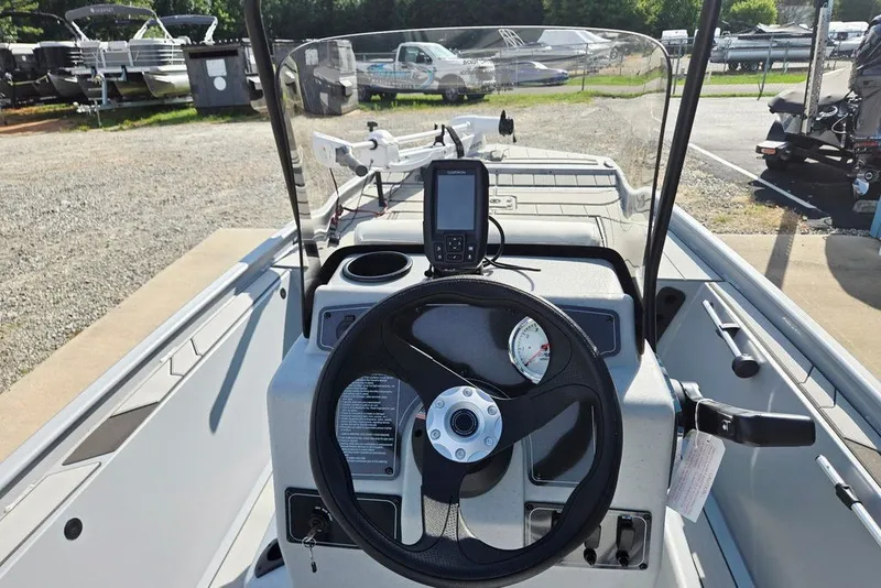 Slide: The Image of 2026 Tracker Bass Tracker Classic CC boat dashboard with steering wheel and navigation system. - 24