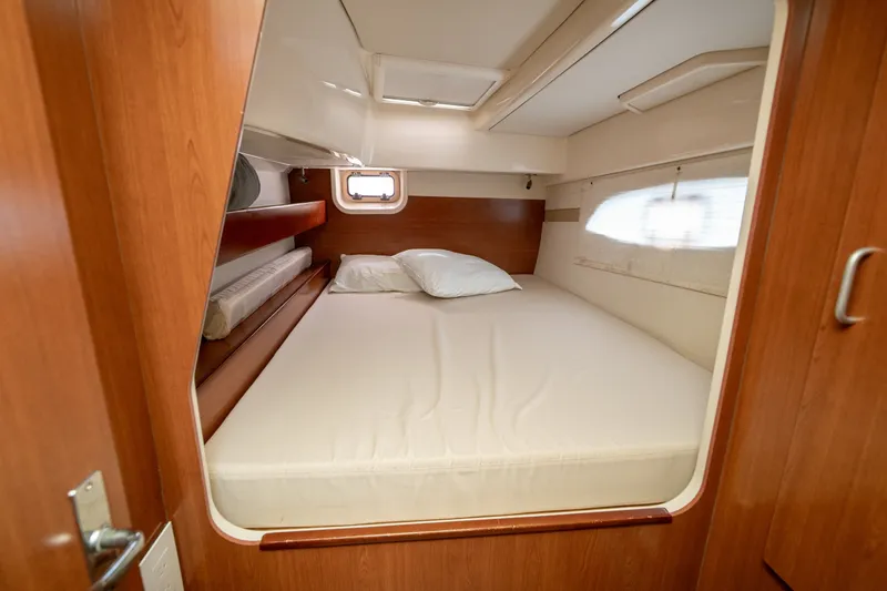 Slide: The Image of Cozy cabin interior of 2011 Leopard 38 yacht with wooden finish and comfortable bedding. - 87
