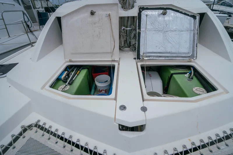 Slide: The Image of Open storage compartments on a 2011 Leopard 38 catamaran, revealing equipment and supplies. - 154