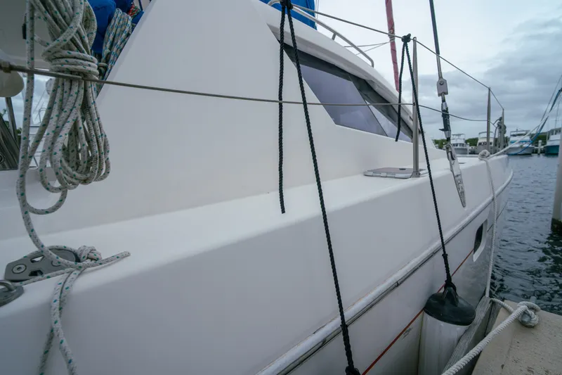 Slide: The Image of Leopard 38 catamaran from 2011 docked at marina, showcasing sleek design and rigging. - 50