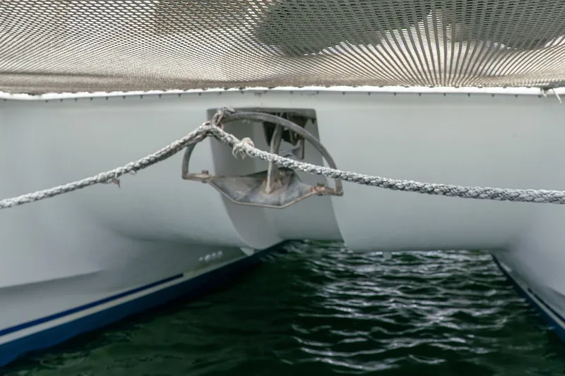 Slide: The Image of 2011 Leopard 38 catamaran anchor and netting over water. - 163