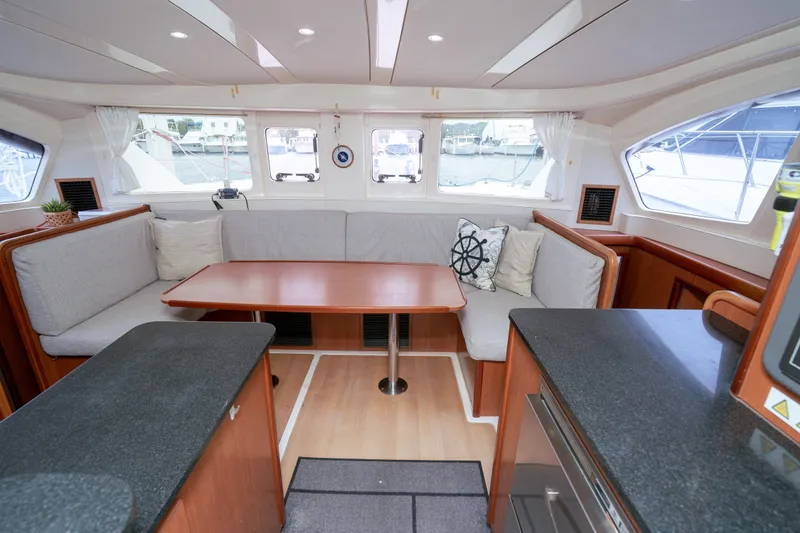 Slide: The Image of Spacious interior of 2011 Leopard 38 catamaran with cozy seating and elegant wood finishes. - 106