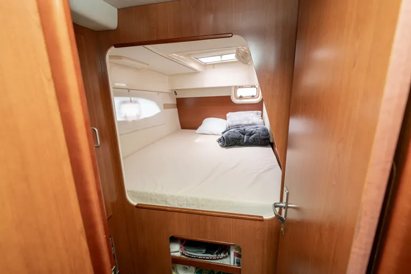 Slide: The Image of Cozy cabin interior of 2011 Leopard 38 catamaran with comfortable bedding and wooden finish. - 122