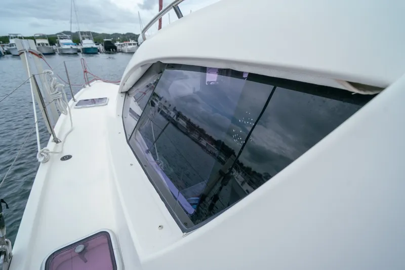 Slide: The Image of 2011 Leopard 38 catamaran docked, showcasing sleek design and reflective windows. - 33