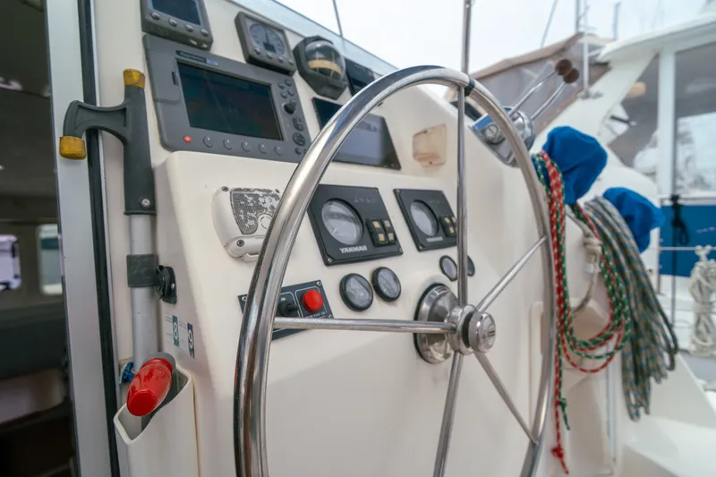 Slide: The Image of Steering wheel and control panel of a 2011 Leopard 38 catamaran yacht. - 143