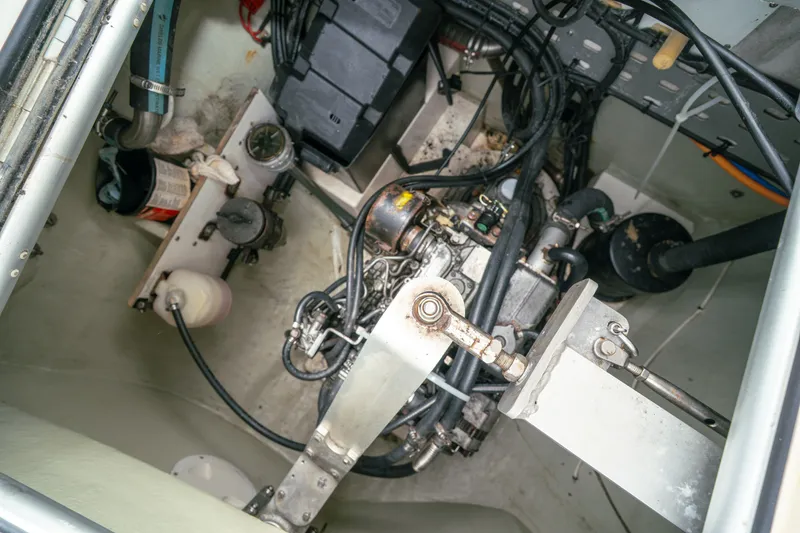 Slide: The Image of Engine compartment of a 2011 Leopard 38 catamaran, showcasing mechanical components and wiring. - 148