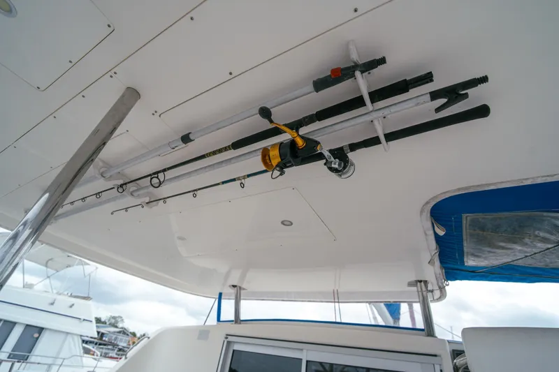 Slide: The Image of Fishing rods stored on a 2011 Leopard 38 catamaran's ceiling, showcasing marine equipment. - 53